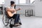 Young musician in wheelchair playing guitar at home