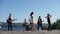 Young musicians perform on the pier, they sing and play musical instruments