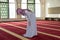 Young muslim girl pray in mosque