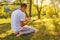 Young Muslim man pray in nature at sunset time