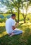 Young Muslim man pray in nature at sunset time