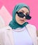 Young muslim woman, fashion and portrait by wall with trendy gen z aesthetic, beauty and art deco in city. Edgy islamic