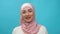 Young Muslim woman in hijab smiling happy enjoying successful. Traditional Islamic culture and religion concept. Arabian