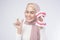 Young muslim woman holding invisalign braces and an artificial Dental Model Of Human over white background studio, dental