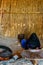 Young muslim woman with masked face cooking bread in a bedouin dwelling