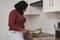 Young muslim woman smiling and preparing Spanish potato omelette.