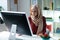 Young Muslim woman working on computer feeling overloaded