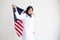 Young Muslim women exchange Students scholarship wear holding america flag over white background concept for hijab girl Islam.