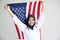 Young Muslim women exchange Students scholarship wear holding america flag over white background concept for hijab girl Islam.