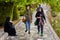 Young Muslim women in hijabs, walking in park near river.