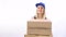 Young naked girl in blue overalls delivers boxes to customer