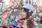 Young naturally beautiful woman near the blooming tree in spring time.