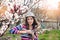 Young naturally beautiful woman near the blooming tree in spring time.