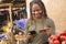 young nigerian woman selling in a local nigerian market using her mobile phone and credit card to do a transaction online smiling