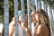 Young, non-conformist Latino and Hispanic boy and girl couple, looking at each other in love through a fence. Concept love,