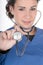 Young nurse, blue scrubs, focus on stethoscope