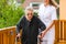 Young nurse and female senior with walking frame