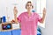 Young nurse woman working at pain recovery clinic relax and smiling with eyes closed doing meditation gesture with fingers