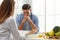 Young nutritionist consulting patient at table