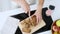 Young nutritionist hands cutting carrot cake into small pieces in the kitchen at home.