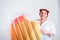 Young obese woman in casual clothes with inflatable ice-cream on a white background. Bodypositive and improper nutrition