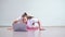 A young obese woman does push-ups. The girl is engaged in fitness at home on the mat and watches a training video on a