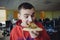 A young office worker eating delicious pizza against a background of office space. Fast food a break at work