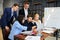 Young office workers using laptop at workplace