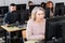 Young and older businesswomen and businessmen in open plan office