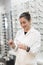 Young optician woman in her eyeglasses store