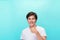 Young optimistic man isolated on blue background showing thump up with positive emotions of content and happiness. Concept of