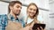 Young Optimistic Spouses Resting After Cleaning Kitchen