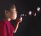 Young oriental girl blowing bubbles