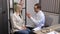 A young otolaryngologist doctor gives a consultation to a female patient. A doctor explains how to wear a hearing aid to a woman