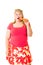 Young overweight blond woman eating raw carrot