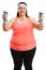 Young overweight woman exercising with dumbbells
