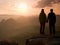 Young pair of hikers hand in hand on the peak of rock empires park and watch over the misty and foggy morning valley to Sun. Beaut