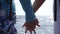 Young pair holding hands of each other standing on ocean coast. Couple of lovers resting on resort and spending time