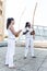 Young pair partners capoeira, berimbau musical instrument in their hands