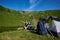 Young pair resting near camping against lake in mountains at summer day