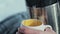 Young pair in wood. Man pours tea from a thermos