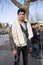 Young Pakistan Refugee, a Young Man, posing with people from Afghanistan, in background in a Belgrade park, during refugee crisis