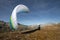 Young paraglider pilot exercises with his paraglider pulling up in the wind, the so-called ground handling