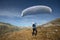 Young paraglider pilot uses his paraglider to play with the wind in the Swiss Alps, the so-called ground handling