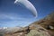 Young paraglider pilot uses his paraglider to play with the wind in the Swiss Alps, the so-called ground handling