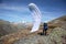 Young paraglider pilot uses his paraglider to play with the wind in the Swiss Alps, the so-called ground handling