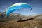 Young paraglider pilot uses his paraglider to play with the wind in the Swiss Alps, the so-called ground handling