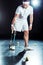 young paralympic tennis player with leg prosthesis holding
