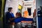 Young paramedic in medical uniform sits with phone in his hands in the ambulance car