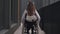 Young paraplegic woman rolling wheelchair outdoors leaving. Portrait of slim beautiful disabled Caucasian elegant